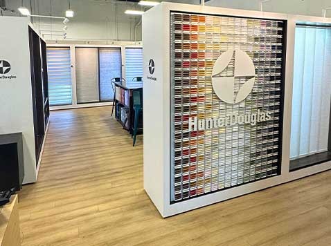 Showroom featuring various blinds, shades, textiles, and color swatches..